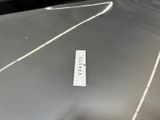 a sticker on the hood of a silver car