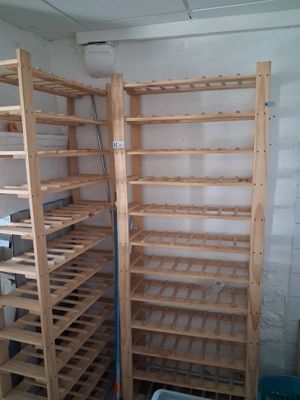 a rack of wine bottles in the corner of a room
