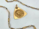 gold plated necklace with a picture of a woman ' s face on it