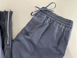 two pairs of pants with zippers on them sitting on a table