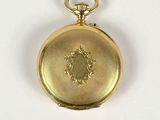 an image of a gold pocket watch on a white surface