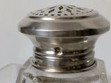 a glass salt and pepper shaker sitting on a table