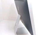 a computer monitor sitting on a stand on a table
