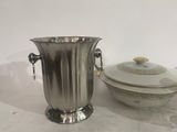 a silver ice bucket and a bowl on a table