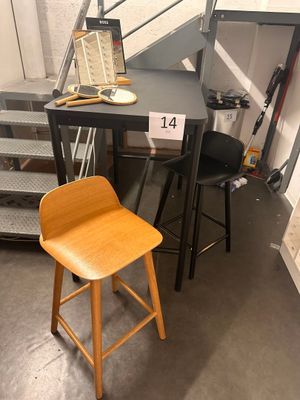 two stools and a table with a laptop on it