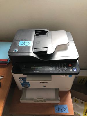 a printer sitting on top of a desk next to a stack of books