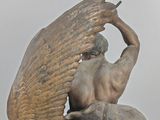 statue of a winged man on a horse with a bird on its back