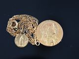 a close up of a coin and a chain on a table