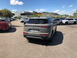 many cars parked in a parking lot with a sky background