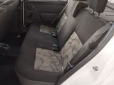 the back seat of a car with a seat belt in a parking lot