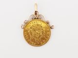a close up of a gold coin on a white surface