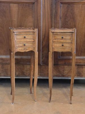 two wooden tables with drawers on them in front of a wooden door