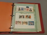 a red binder with stamps on it and a picture of a dog on it