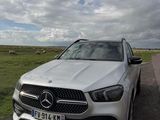 the mercedes gle is parked on the side of the road