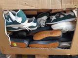 many pairs of shoes in a box on the floor