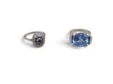 a pair of rings with a blue topaz stone and black diamonds