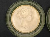pair of two glass plates with two heads of a woman and a man on them