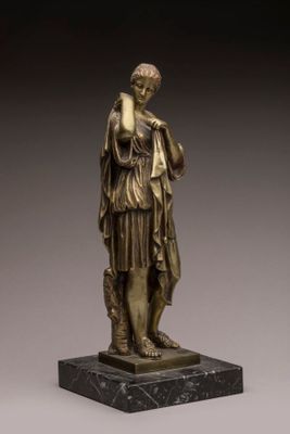 an image of a bronze statue of a woman holding a book