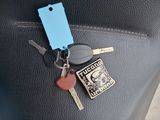 a car key and a keychain on the back seat of a car