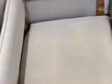 a white chair with a wooden arm rest and a white chair with a wooden arm rest and a white chair with a wooden arm rest and a white arm
