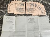 some papers are sitting on top of a table with a bunch of cards