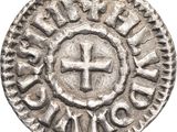 une pièce d'argent sur laquelle figure une croix au centre