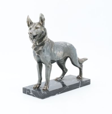 statue of a dog standing on a marble base on a white background