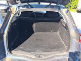 the back of a car with its trunk open in a parking lot