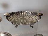 a silver bowl sitting on top of a glass table