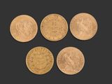 four different types of gold coins on a black background