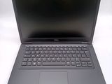 dell laptop computer with a black keyboard on a white surface