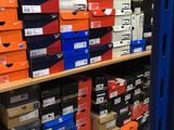 boxes of various sizes and colors are stacked on a shelf in a store