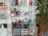 a glass display case with a lot of cell phones in it