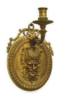 gold plated candle holder with a lion head on top of it