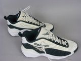they are two pairs of reebok shoes on a gray surface