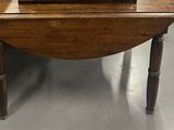 une petite table en bois sur laquelle est posée une horloge