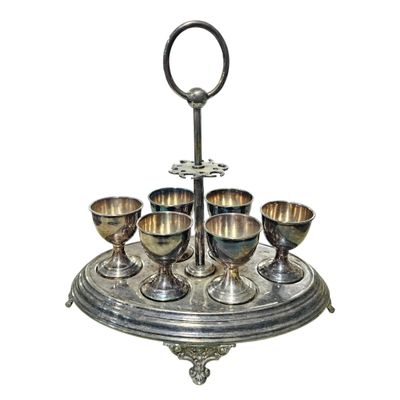 a silver tray with silver cups on top of it