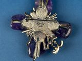 silver and amethorate flower broochle on a blue background