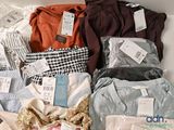 a lot of clothes that are sitting on a table