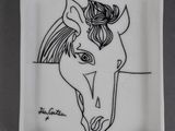 a white plate with a drawing of a horse on it