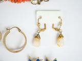 a lot of jewelry on a table with a white background