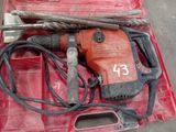 a red box with a hammer and other tools in it