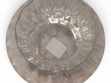 a glass plate with a diamond on it on a white surface