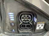 a close up of a car ' s rear door with an electrical outlet