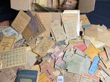 a box full of old paper and a bunch of old books