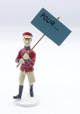 a small figurine of a man holding a sign
