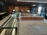 an image of a kitchen with a counter and a glass case