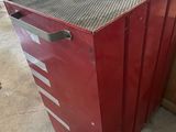 a red cabinet with a metal top in a room
