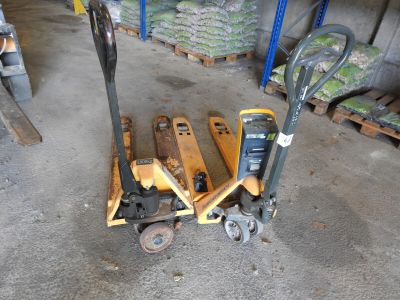 a small hand truck that is sitting next to a pile of pallets
