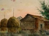 two large bales of hay in front of a building